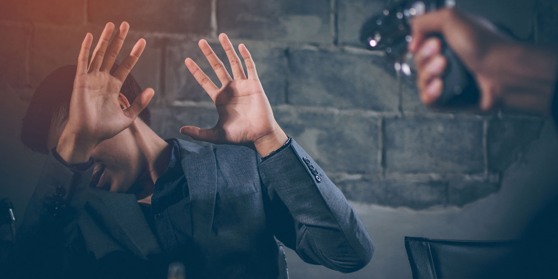 criminal aiming gun at man